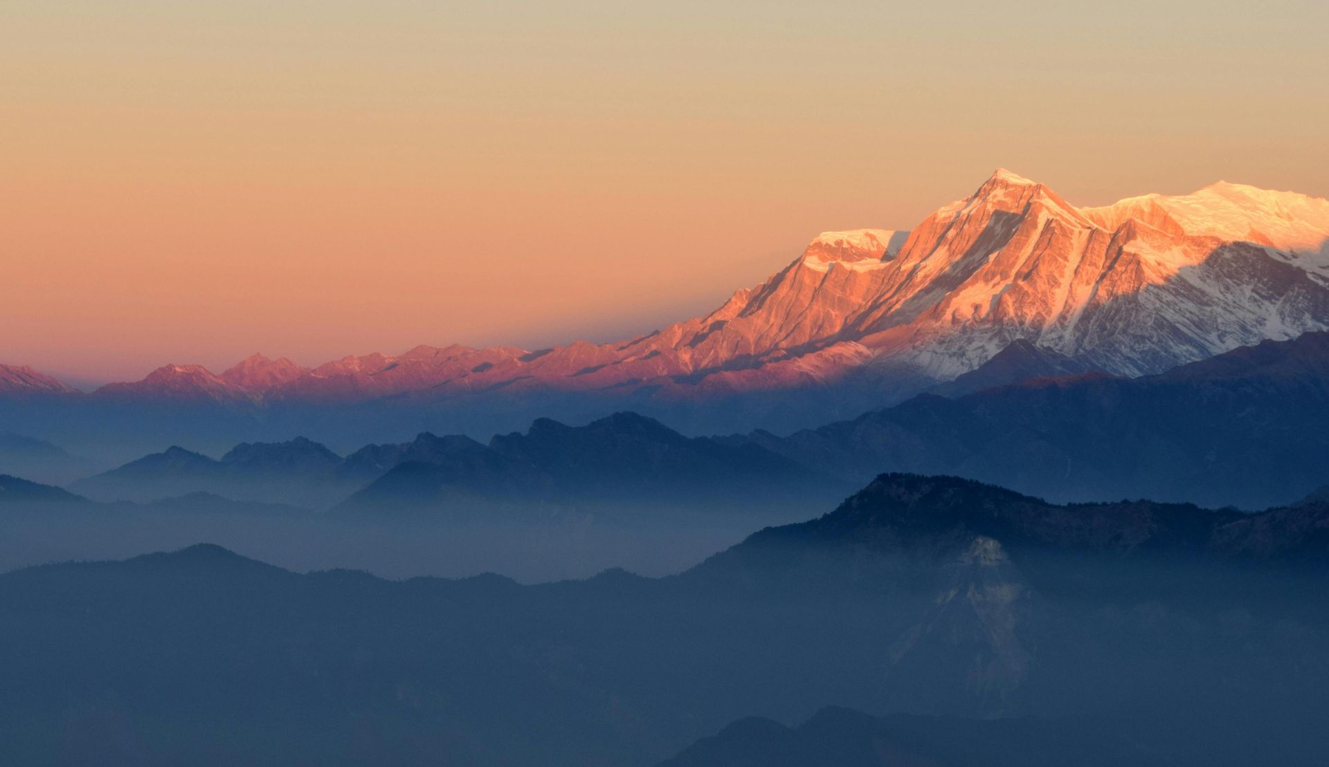 A breathtaking view of the Himalayan mountains at sunrise, showcasing the majestic peaks and serene atmosphere.